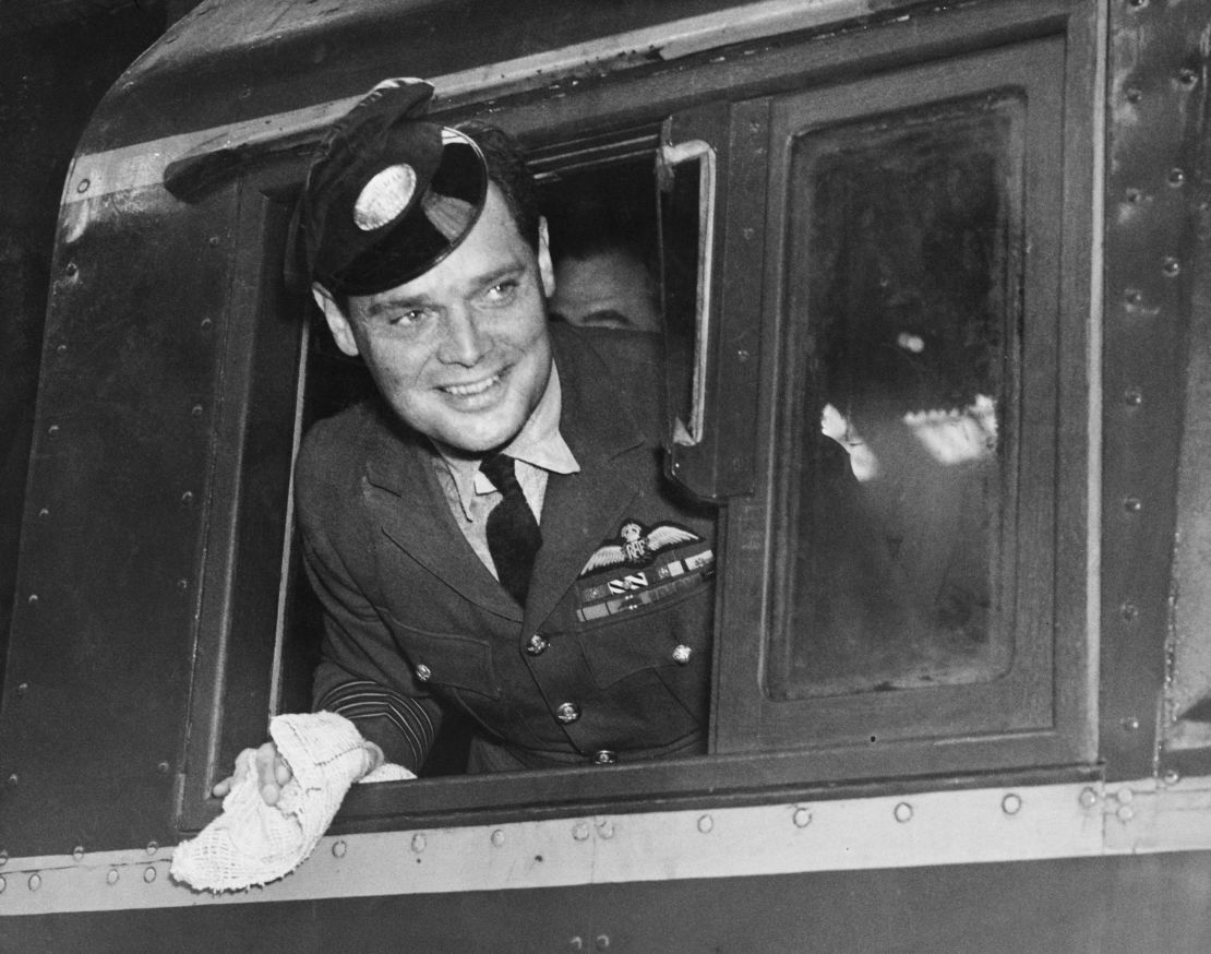 Douglas Bader poses on a new Southern Railway engine at Brighton, England, wearing an engine driver's peaked cap in September 1947.