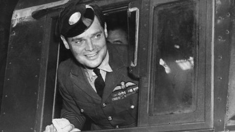 Douglas Bader poses on a new Southern Railway engine at Brighton, England, wearing an engine driver's peaked cap in September 1947.