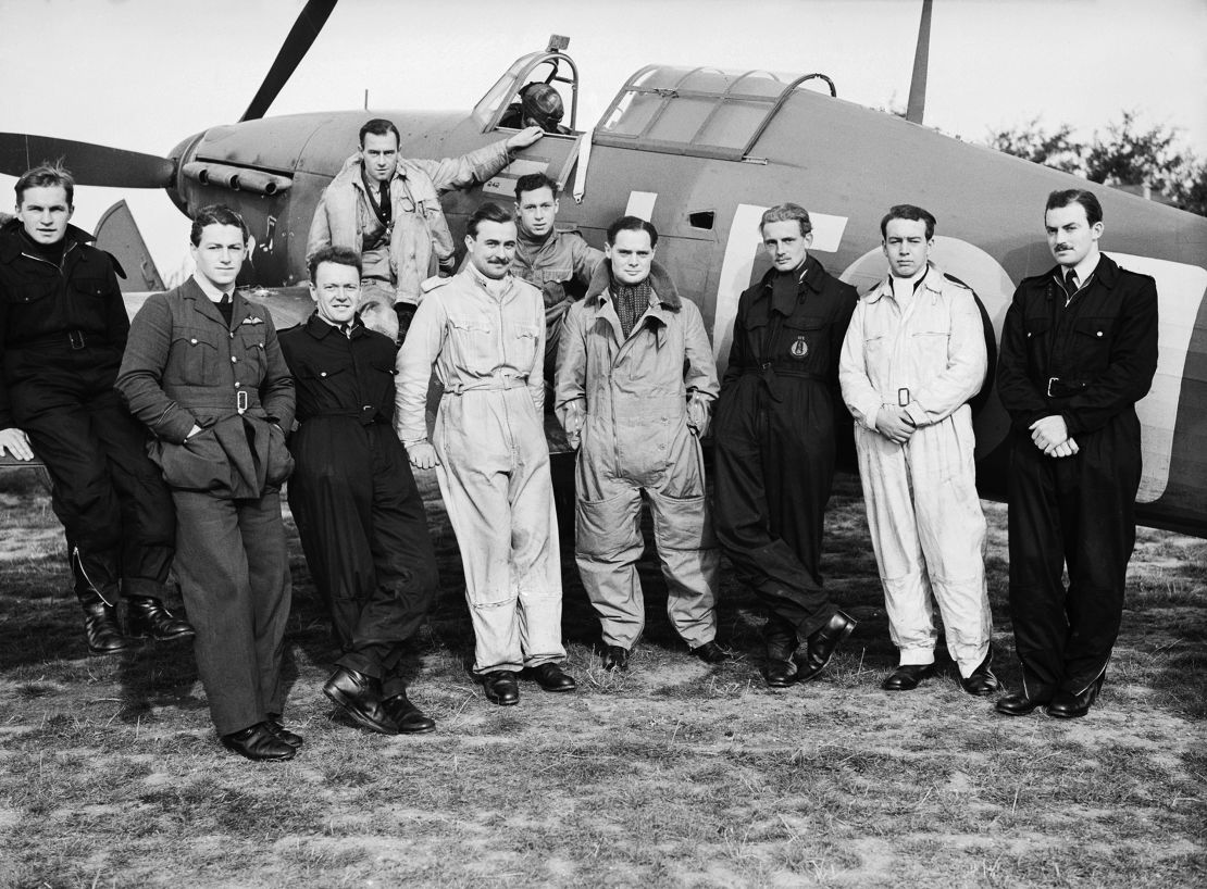 Squadron Leader Douglas Bader, front center fourth from right,  stands beside his Hawker Hurricane Mk1 with the men of Royal Air Force No. 242 Squadron during the Battle of Britain in early September 1940 at RAF Duxford near Cambridge, England. 