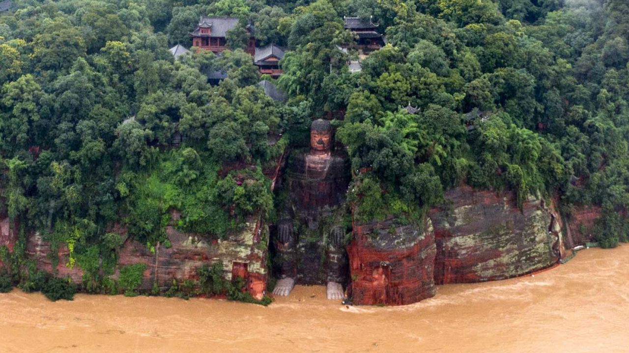 This aerial photo taken on August 18, 2020 shows the Leshan Giant Buddha surrounded by floodwaters following heavy rains in Leshan in China's southwestern Sichuan province. - Continuous rainfall has engulfed streets and displaced residents in southwestern China's Sichuan province, with soldiers evacuating tens of thousands of people from rising floods. (Photo by STR / AFP) / China OUT (Photo by STR/AFP via Getty Images)