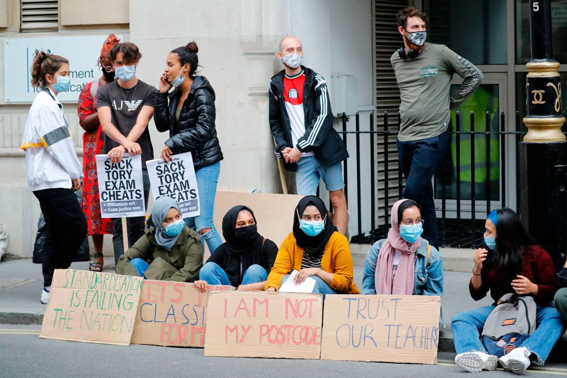 Students hold placards as they protest outside the Department for Education in central London on August 14.
