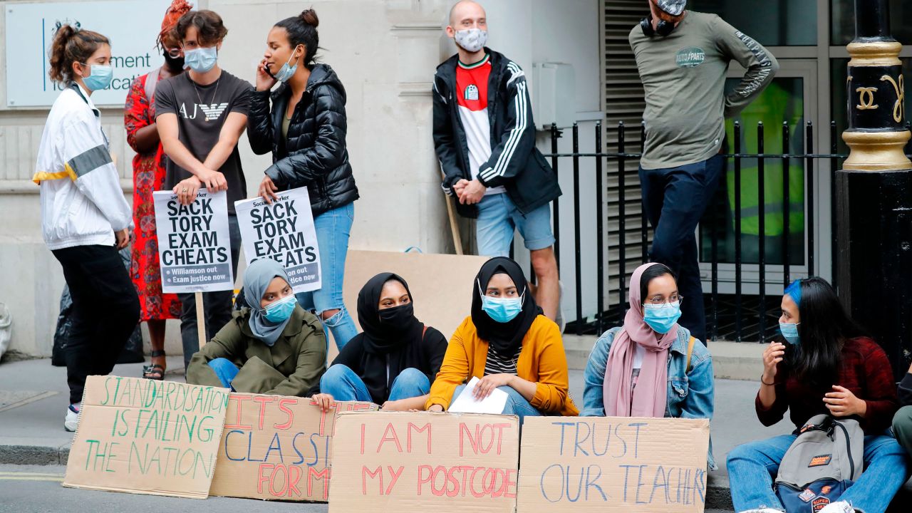 Students hold placards as they protest outside the Department for Education in central London on August 14.