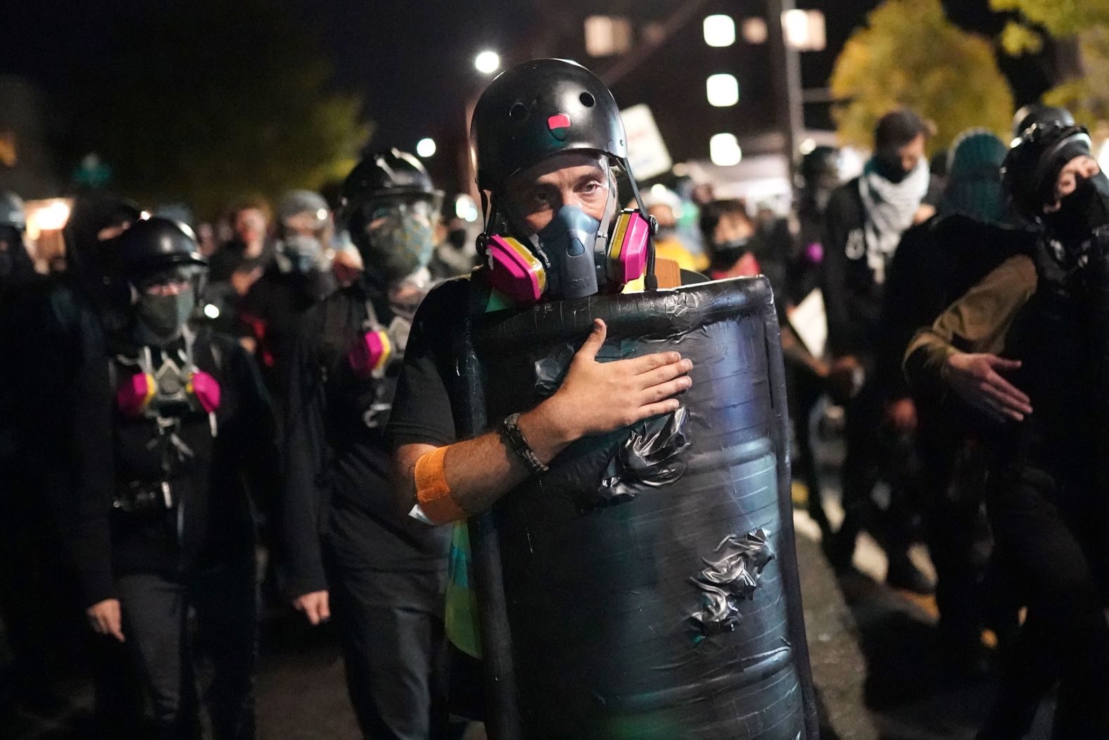 A protester slaps his shield while marching toward the Portland Police Bureau's North Precinct on August 10.