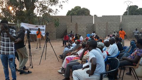 YAIM members speak to community members about the dangers of irregular migration.