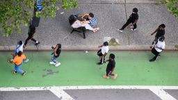 NEW YORK, NEW YORK - AUGUST 17: People sit on a traffic island in Kips Bay as the city continues Phase 4 of re-opening following restrictions imposed to slow the spread of coronavirus on August 17, 2020 in New York City. The fourth phase allows outdoor arts and entertainment, sporting events without fans and media production. (Photo by Noam Galai/Getty Images)