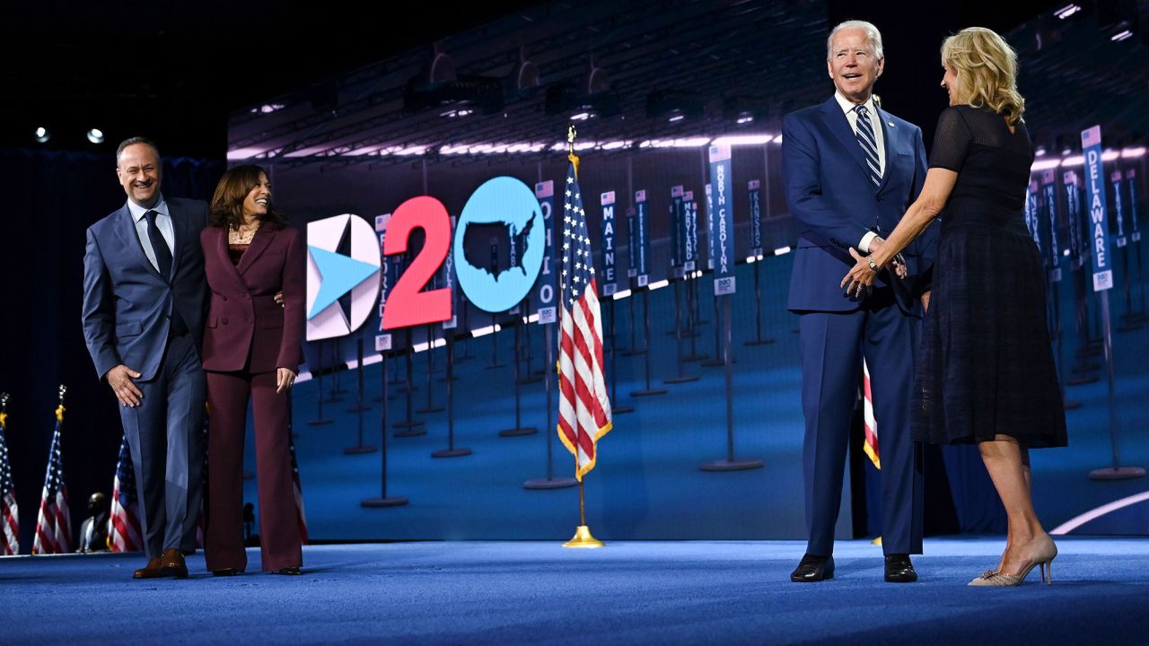 The Democratic presidential ticket stands on stage together — but socially distanced — after US Sen. Kamala Harris accepted the vice presidential nomination on Wednesday. Harris is with her husband, Douglas Emhoff. Biden is with his wife, Jill.