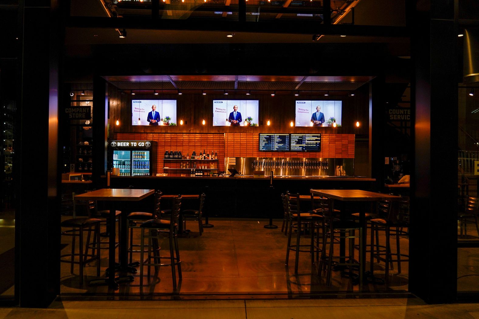 Television screens show Obama's speech from Goodcity Brewing, which is across from the Fiserv Forum in Milwaukee. The Fiserv Forum is where the convention was originally supposed to take place.