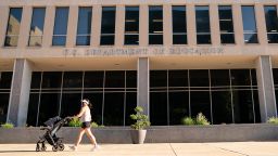 A pedestrian walks with a baby stroller in front of the U.S. Department of Education building in Washington, D.C., U.S., on Tuesday, Aug. 18, 2020. U.S. public schools need $200 billion in federal aid to be able to safely open for the fall semester with the coronavirus continuing to circulate witnesses told a House panel this month. Photographer: Erin Scott/Bloomberg via Getty Images