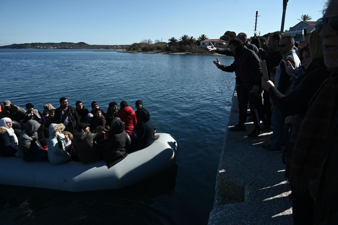 Migrants are seen on an inflatable boat as local residents prevent them from disembarking on the Greek island of Lesbos on March 1.