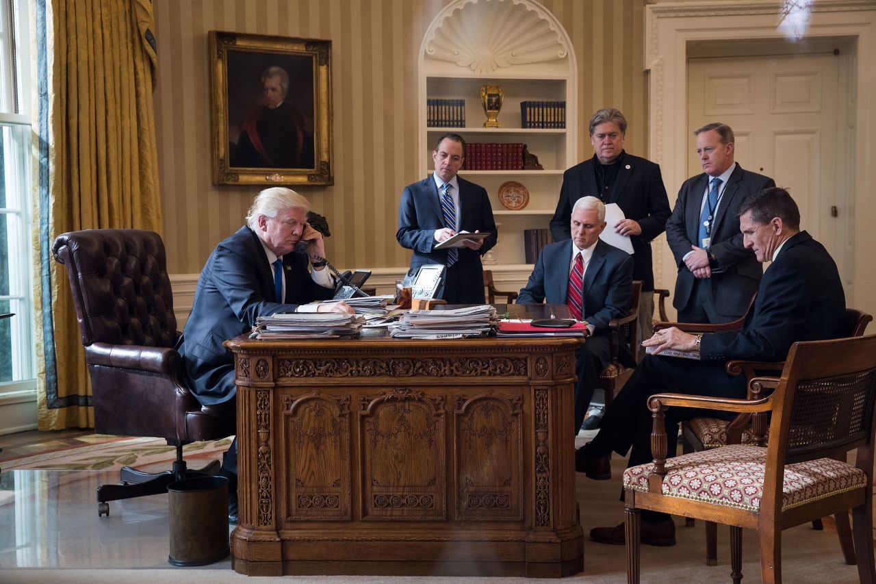 Bannon stands in the Oval Office as Trump speaks on the phone with Russian President Vladimir Putin in January 2017. Also pictured, from left, are White House Chief of Staff Reince Priebus, Vice President Mike Pence, press secretary Sean Spicer and national security adviser Michael Flynn.