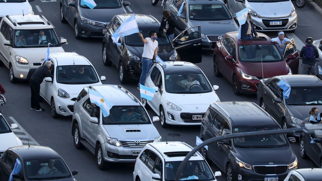 Protesters in cars drive along 9 de Julio Avenue waving flags in Buenos Aires on Monday.