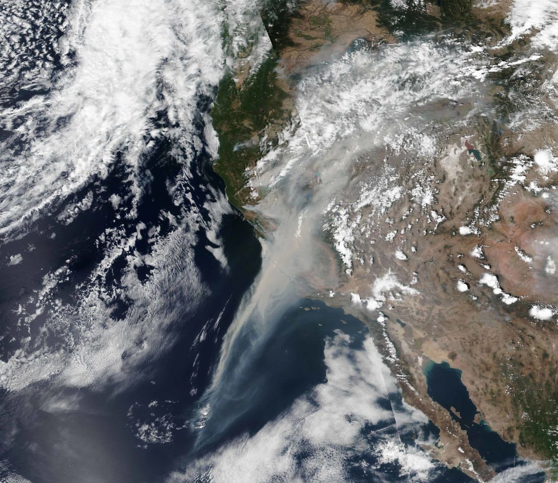 Smoke from the California wildfires stretches some 600 miles off the coast in a NASA satellite image Wednesday. 