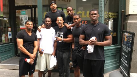 Hector Guadalupe, center, with graduates of his program in New York before Covid-19 closed gyms
