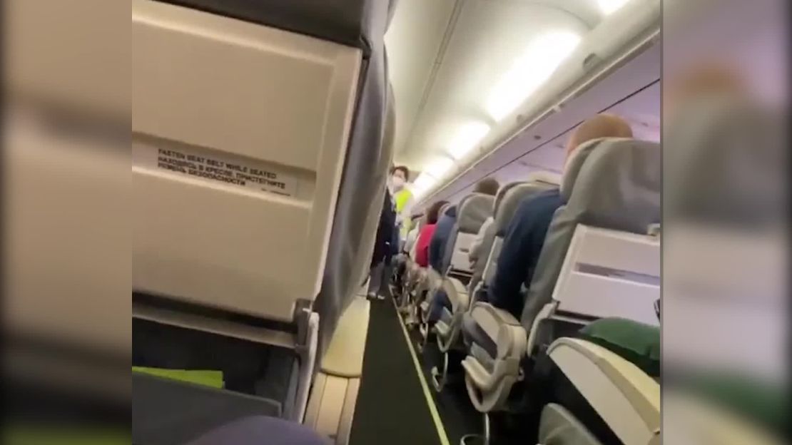 A screenshot taken from a video showing paramedics on a plane about to attend to Navalny after he fell ill in a case of suspected poisoning.