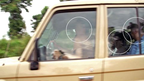 CNN spotted a car tracking the team's movements. Upon approaching the vehicle, most of its passengers tried to hide their faces.