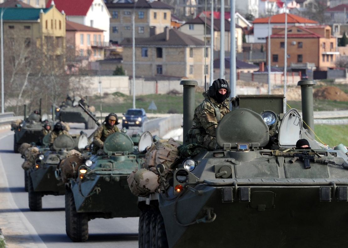 Russian armored vehicles drive on the road between Simferopol and Sevastopol in Crimea on March 17, 2014. 
