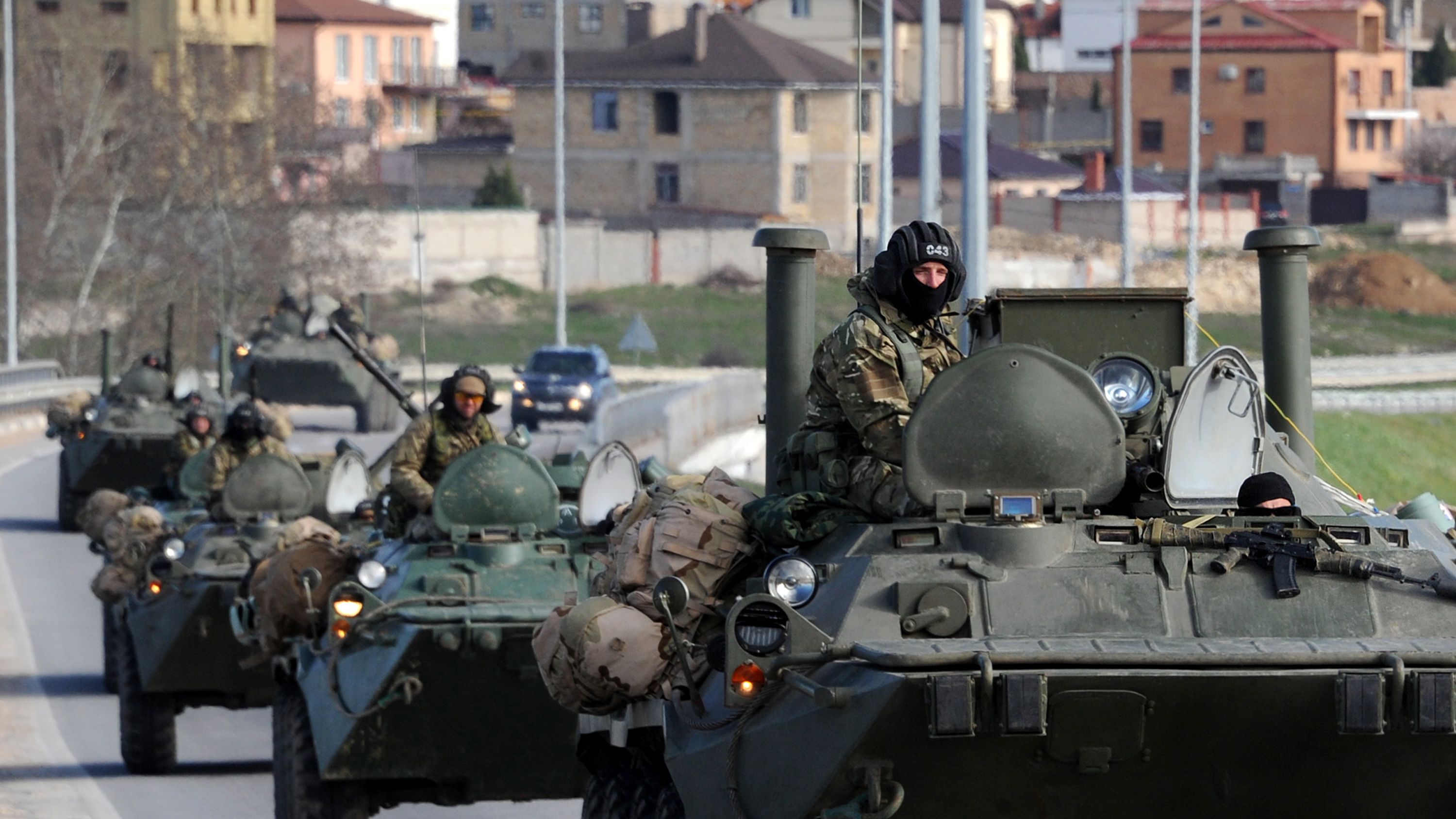 Russian armored vehicles drive on the road between Simferopol and Sevastopol in Crimea on March 17, 2014. 