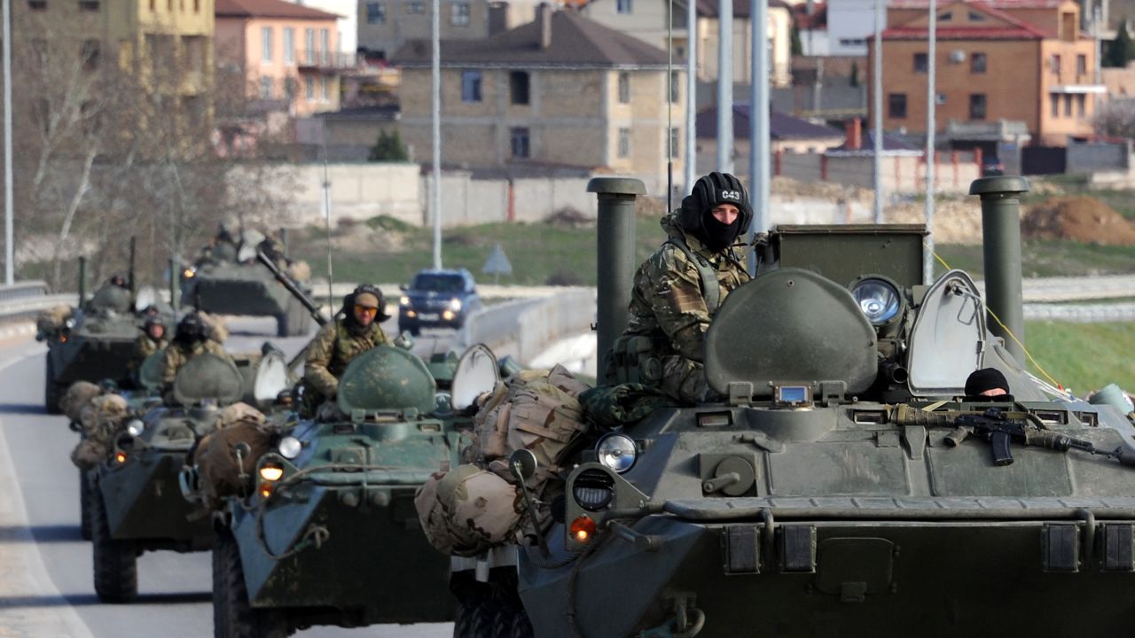 Russian armored vehicles drive on the road between Simferopol and Sevastopol in Crimea on March 17, 2014.