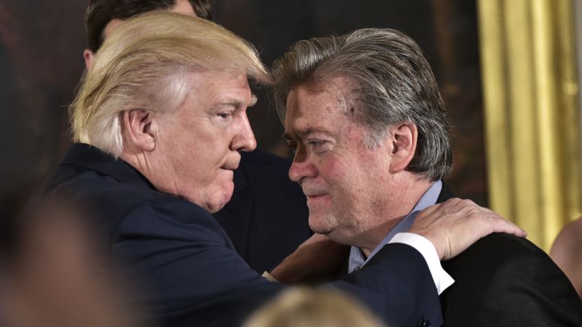 US President Donald Trump (L) congratulates Senior Counselor to the President Stephen Bannon during the swearing-in of senior staff in the East Room of the White House on January 22, 2017 in Washington, DC. / AFP / MANDEL NGAN        (Photo credit should read MANDEL NGAN/AFP via Getty Images)