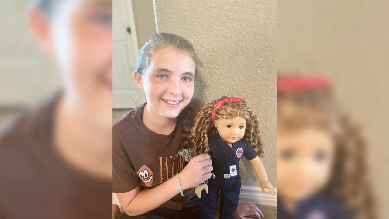 American Girl doll based on EMS provider April O'Quinn held by her niece Lacey.