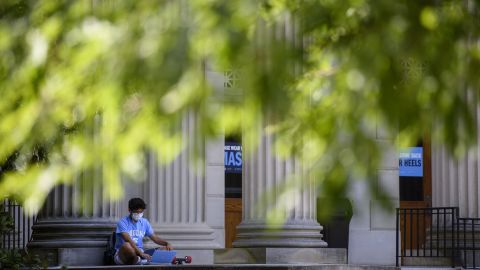 A student studies outside the closed Wilson Library on the campus of the University of North Carolina at Chapel Hill on August 18, 2020 in Chapel Hill, North Carolina. The school halted in-person classes and reverted back to online courses after a rise in the number of COVID-19 cases.