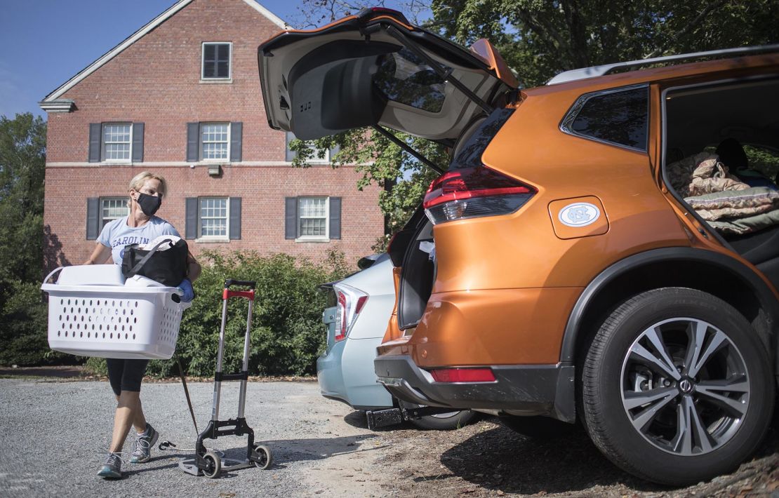 Darlene Genander loads up her vehicle as she helps junior UNC-Chapel Hill student Caitlin Sockin move out of Alderman Residence Hall in Chapel Hill, N.C. on Wednesday, Aug. 19, 2020.