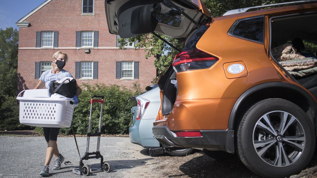 Darlene Genander loads up her vehicle as she helps junior UNC-Chapel Hill student Caitlin Sockin move out of Alderman Residence Hall in Chapel Hill, N.C. on Wednesday, Aug. 19, 2020.