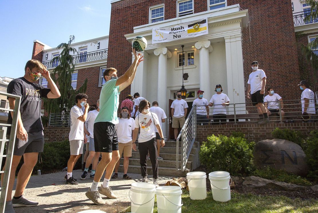 University of Idaho students wear face masks while playing a game outside of Sigma Nu fraternity during fraternity bid day, the final day of the recruitment process, in August.