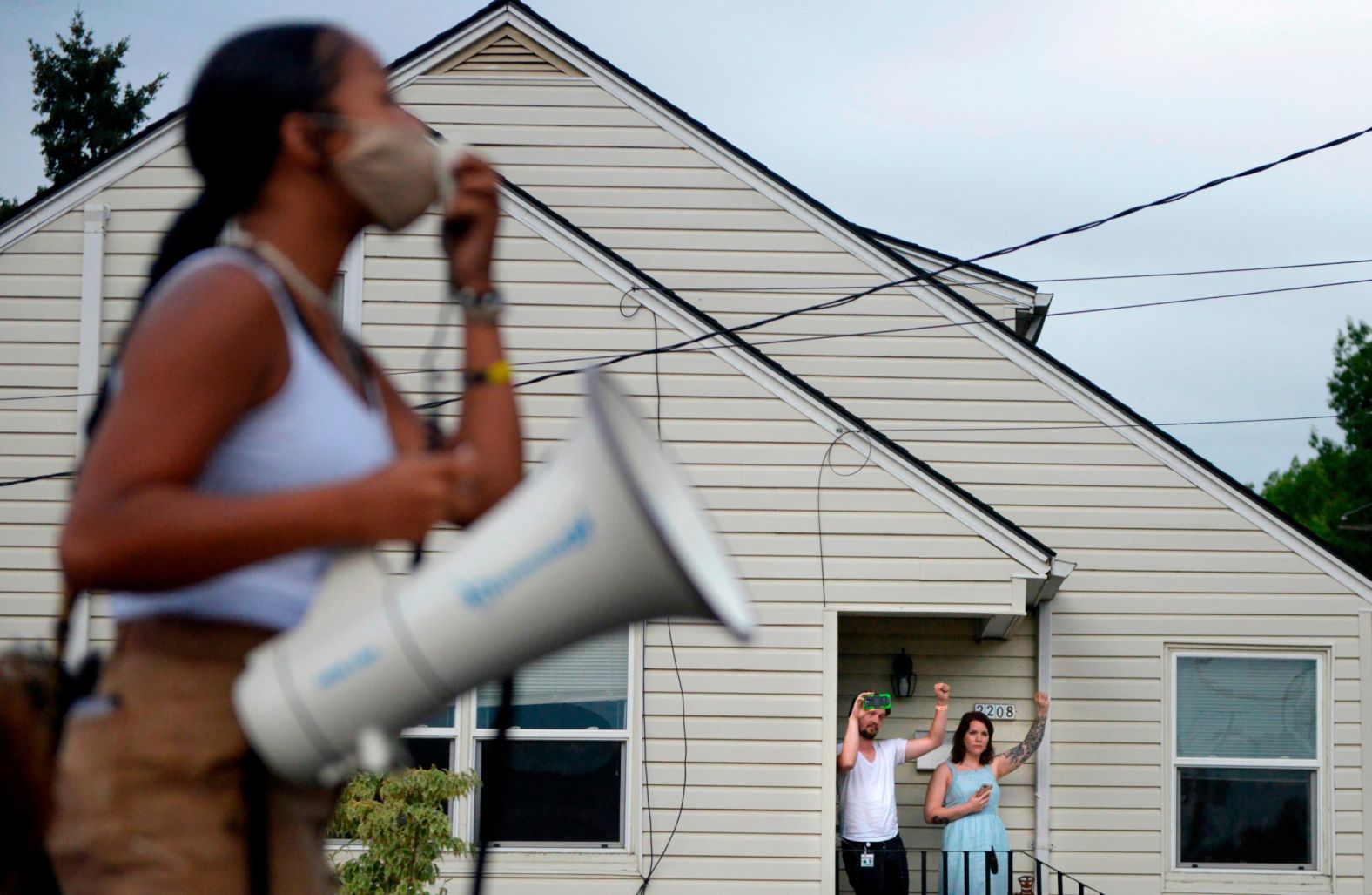 People watch a protest pass by on August 20.