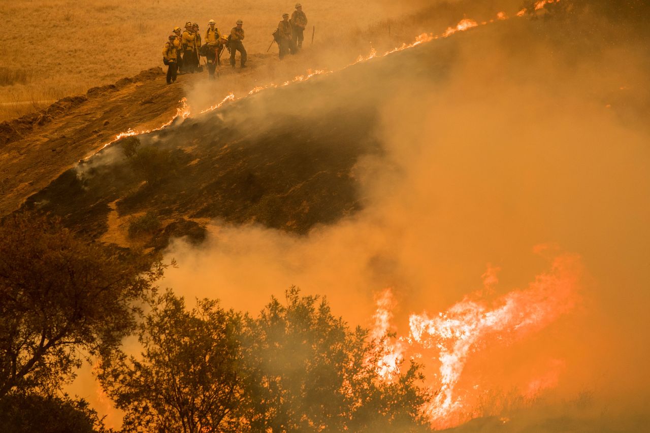 Fire crews maintain a backburn to control the River Fire near the Las Palmas neighborhood in Salinas, California, on August 19, 2020.