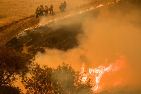 Fire crews maintain a backburn to control the River Fire near the Las Palmas neighborhood in Salinas, California, on August 19.