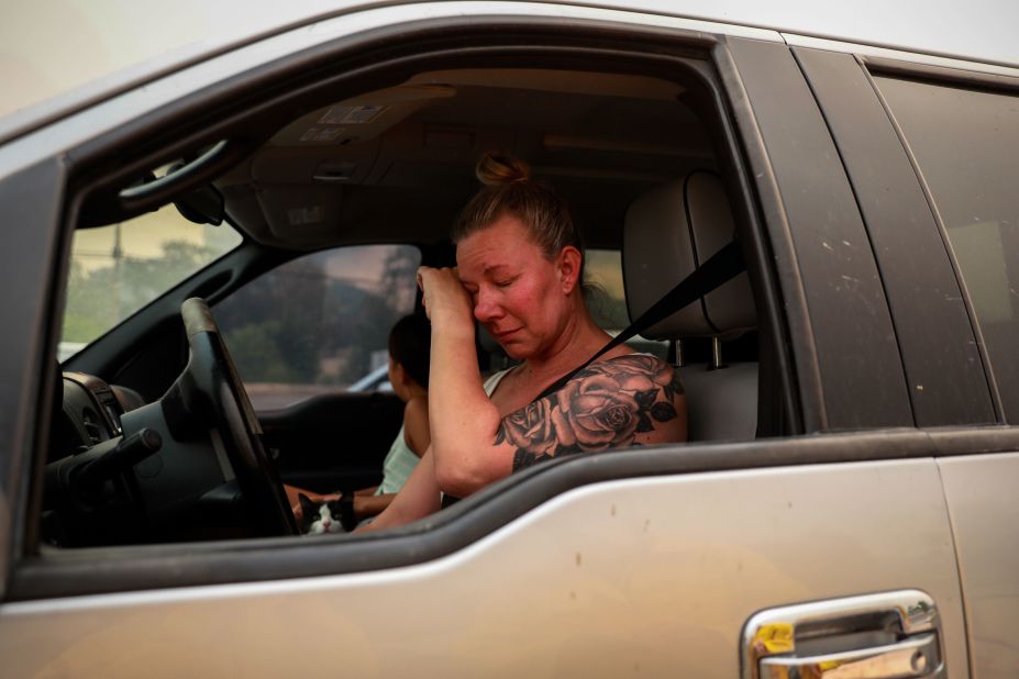 Gina Santos cries in her car after evacuating Vacaville on August 19, 2020.