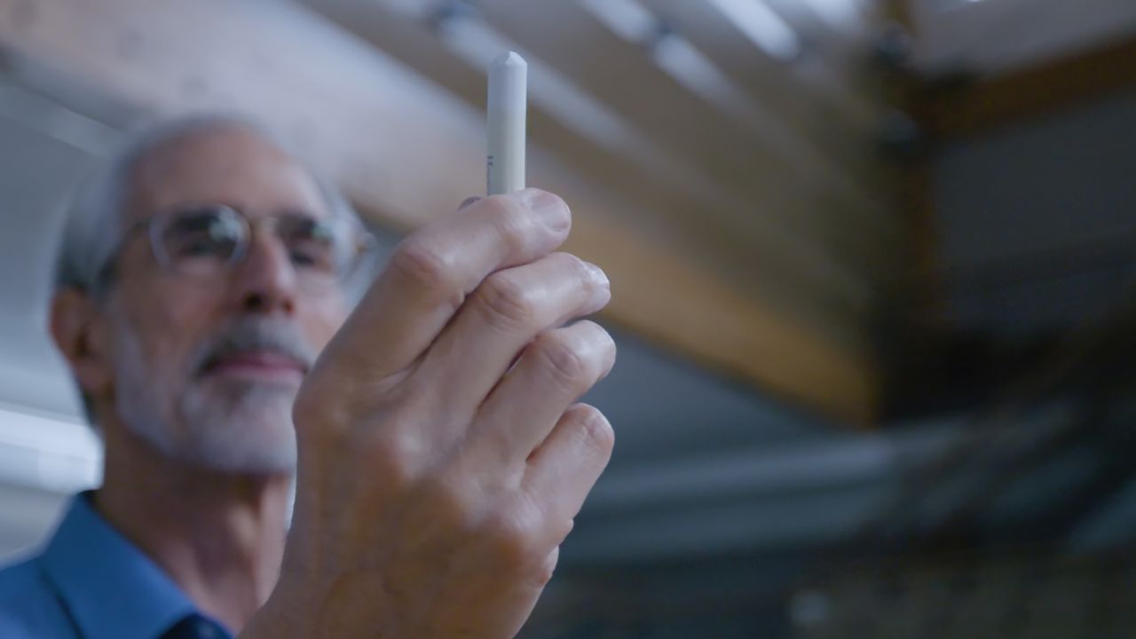 David Eisenbud holds up a stick of Hagoromo, the chalk brand favored among math professors.