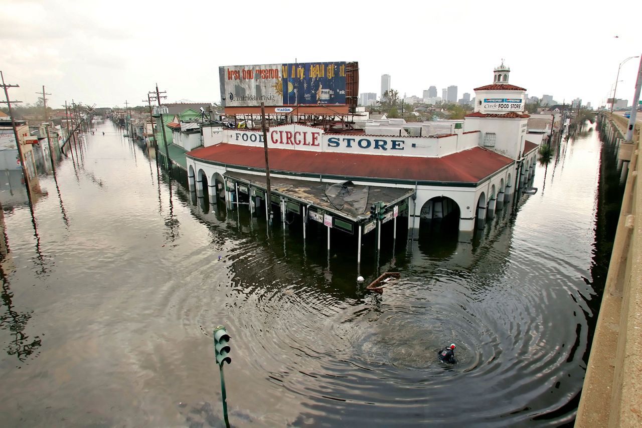 A man swims by the Circle Food Store in flooded New Orleans.