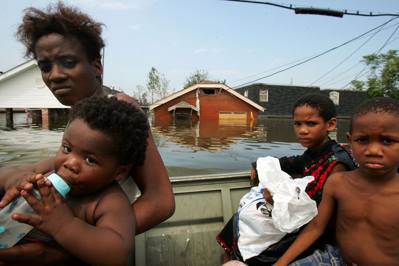 A mother and her children are rescued by boat in New Orleans' Lower Ninth Ward.