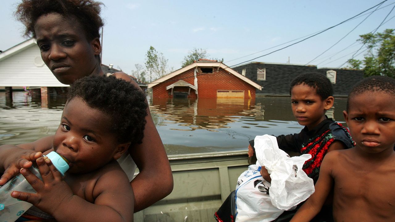 A mother and her children are rescued by boat from New Orleans' Lower Ninth Ward in the aftermath of Hurricane Katrina.