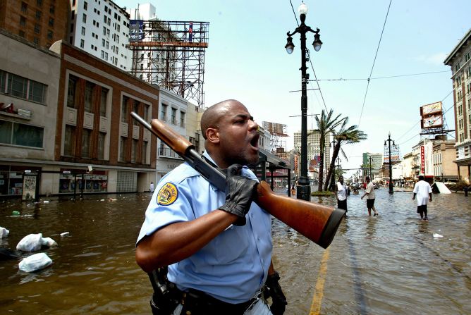 New Orleans police officer Mark Wilson yells at people in stores looters on Canal Street. In Katrina's aftermath, many questioned whether some people accused of looting were just people scavenging for the supplies they needed to survive.