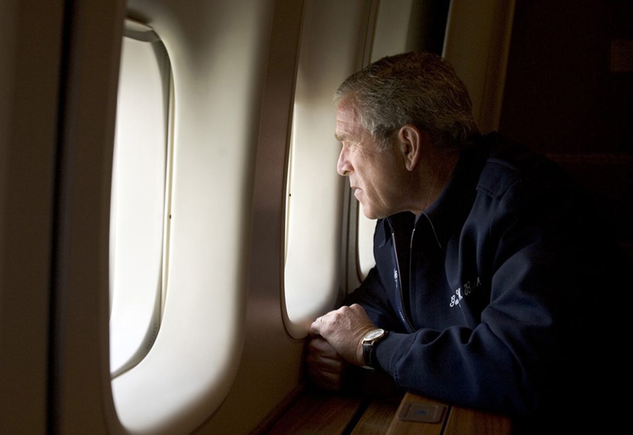 In this handout photo provided by the White House, President George W. Bush looks out over Katrina devastation as he rides Air Force One back to Washington, DC.