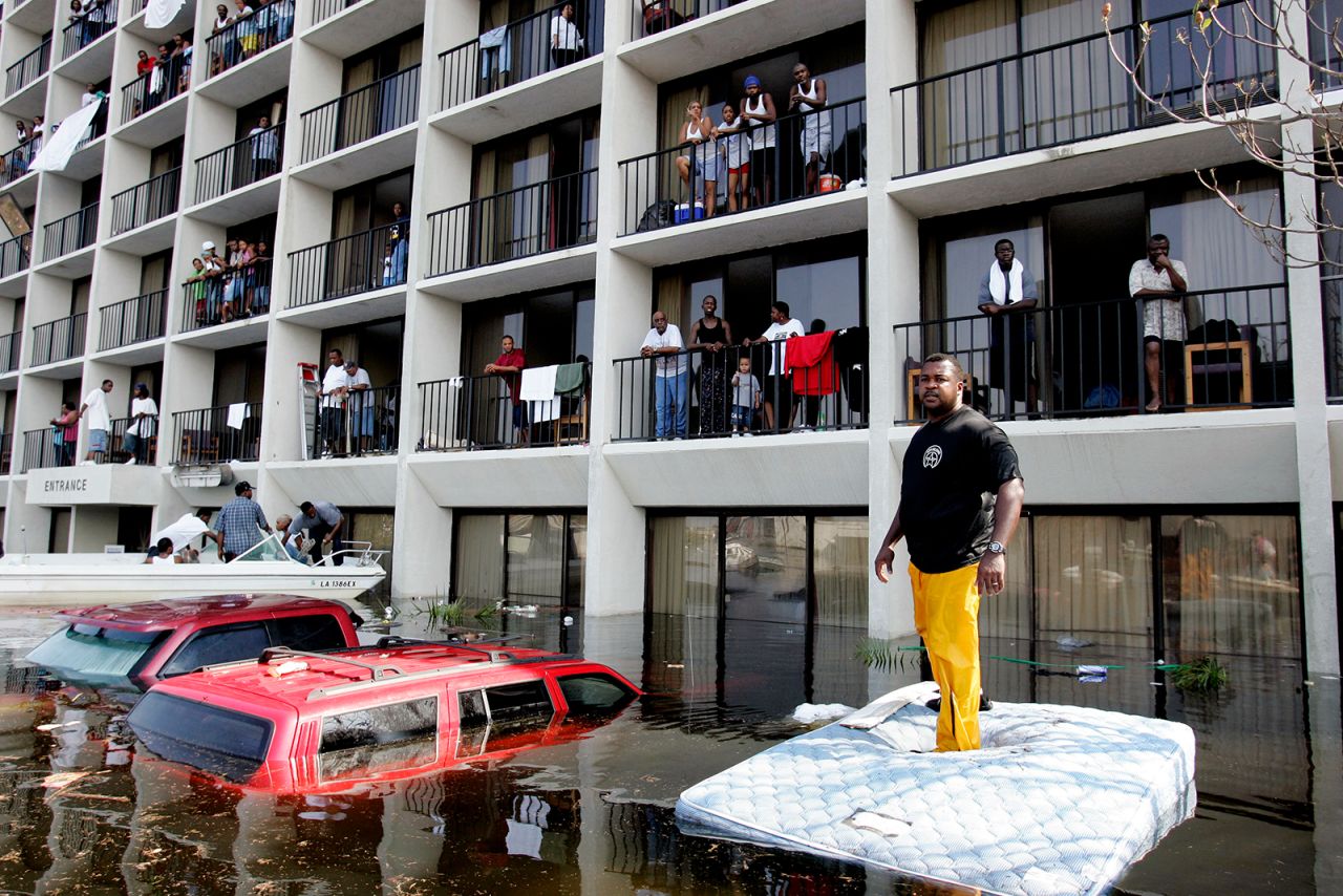 New Orleans police and volunteers use boats to rescue residents from a flooded neighborhood on the east side of New Orleans.