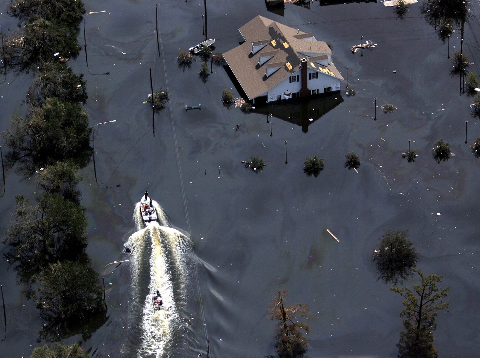 Boats travel down a flooded highway in New Orleans.