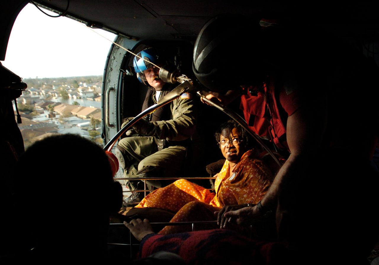Jason Jennison, an aviation survival technician with the US Coast Guard, pulls a Katrina survivor aboard a helicopter in New Orleans.
