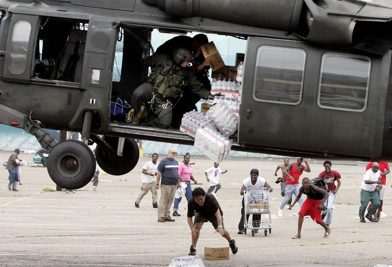 A military helicopter makes a food and water drop near the Convention Center in New Orleans.