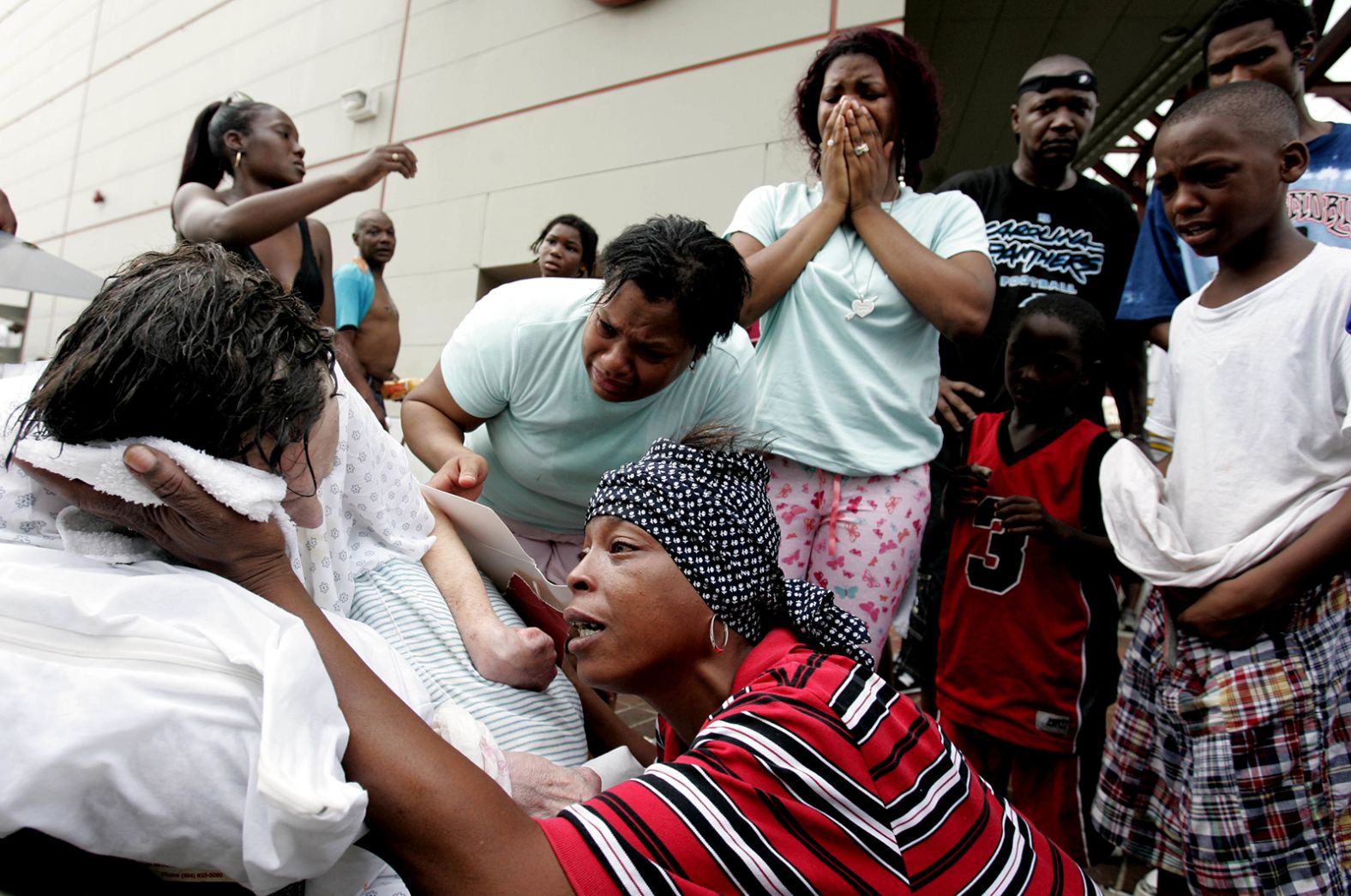 Terri Jones tries to cool Dorthy Divic, an 89-year-old who was overheated and exhausted at the Convention Center in New Orleans.