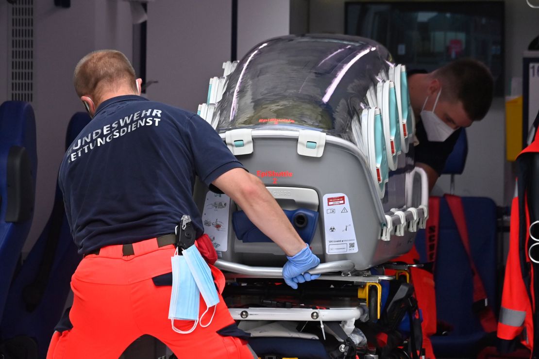 German army emergency personnel load the stretcher that was used to transport Russian opposition figure Alexei Navalny into an ambulance on August 22, 2020 at Berlin's Charite hospital.