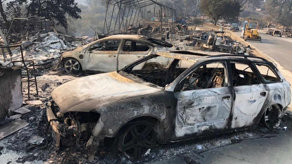 The remains of charred vehicles rest Saturday in a neighborhood near Lake Berryessa in Northern California's Napa County.