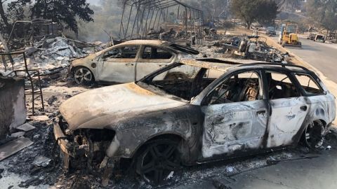 The remains of charred vehicles rest Saturday in a neighborhood near Lake Berryessa in Northern California's Napa County.