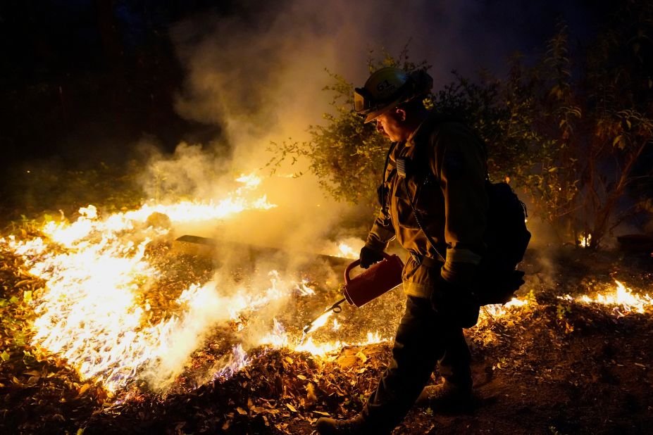 A firefighter monitors the advance of a fire in Boulder Creek on August 21, 2020.