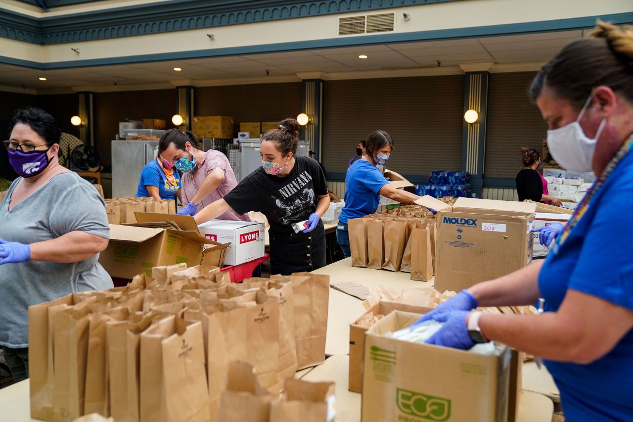 People pack brown-bag lunches at an evacuation center in Santa Cruz, California, on August 21, 2020.