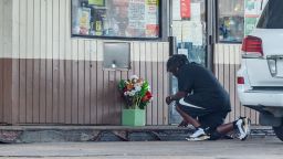 A man kneels to say a prayer outside convenience store on Evangeline Thruway where a man was shot and killed by Lafayette Police. Saturday, Aug. 22, 2020.

Main 1A CP photo
