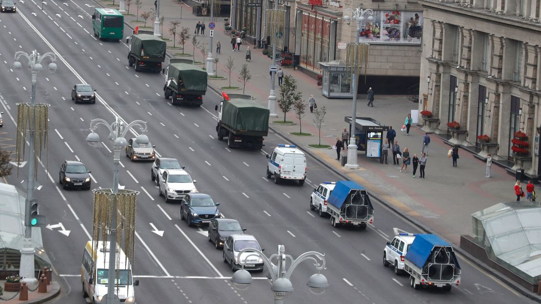 A convoy of police vehicles drives down the street ahead of another scheduled protest in Minsk on Sunday.